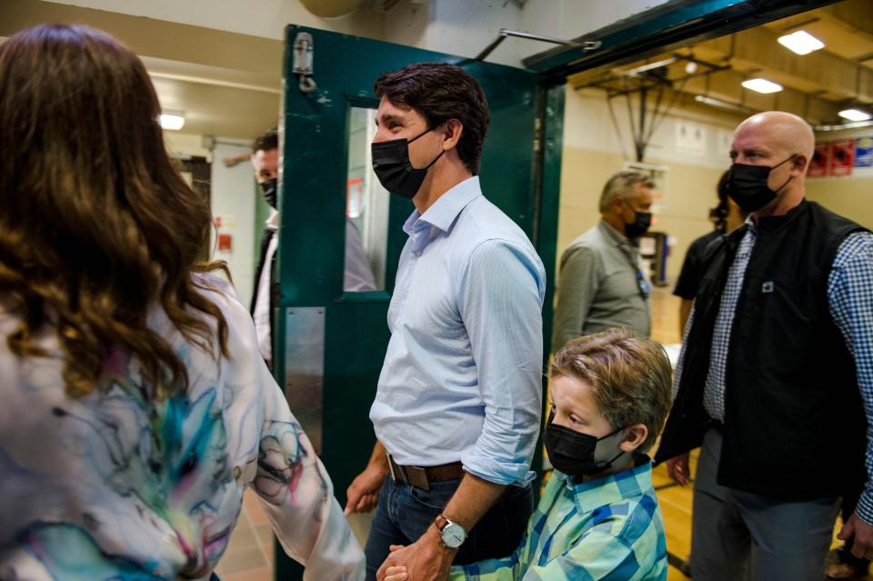 Liberal Party of Canada leader Prime Minister Justin Trudeau(C) with family, leaves after casting his vote in the 2021 Canadian election in Montreal,Quebec on September 20, 2021. - Voters lined up September 20, 2021 to cast ballots in Canadian elections that are headed for a photo finish, with liberal Prime Minister Justin Trudeau's bid for a third term threatened by rookie conservative leader Erin O'Toole's strong challenge. Trudeau called the snap election hoping to parlay a smooth Covid-19 vaccine rollout -- among the best in the world -- into a new mandate to steer the nation's pandemic exit, without having to rely on opposition party support to pass his agenda. (Photo by Andrej Ivanov / AFP) (Photo by ANDREJ IVANOV/AFP via Getty Images)