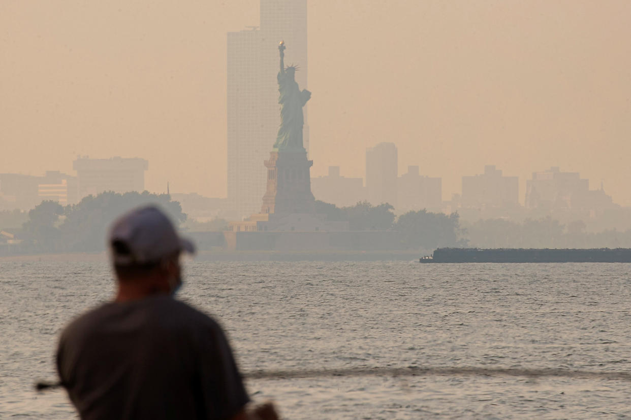 Image: The Statue of Liberty is seen through a cover of wildfire smoke in New York Harbor as seen from Brooklyn, New York (Brendan McDermid / Reuters)