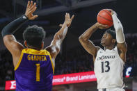 Cincinnati's Tre Scott (13) shoots over East Carolina's Jayden Gardner (1) during the first half of an NCAA college basketball game, Sunday, Jan. 19, 2020, in Cincinnati. (AP Photo/John Minchillo)