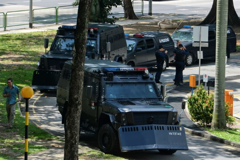 A motorcade of armoured police vehicles, used to transport four Bangladeshi nationals prosecuted under a Singaporean anti-terror law, are seen outside the State Court in Singapore on July 12, 2016