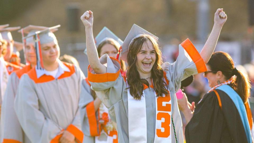 Brooklynn Cendro raises her arms in celebration as her name is read. Atascadero held their 102nd commencement ceremony.