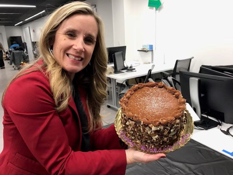 Katie Pecoraro, Maverick program management supervisor, is seen in 2019 holding one of her homemade cakes she brought as part of her happy snack campaign for the Ford Maverick team that was working in seclusion on the secret project.