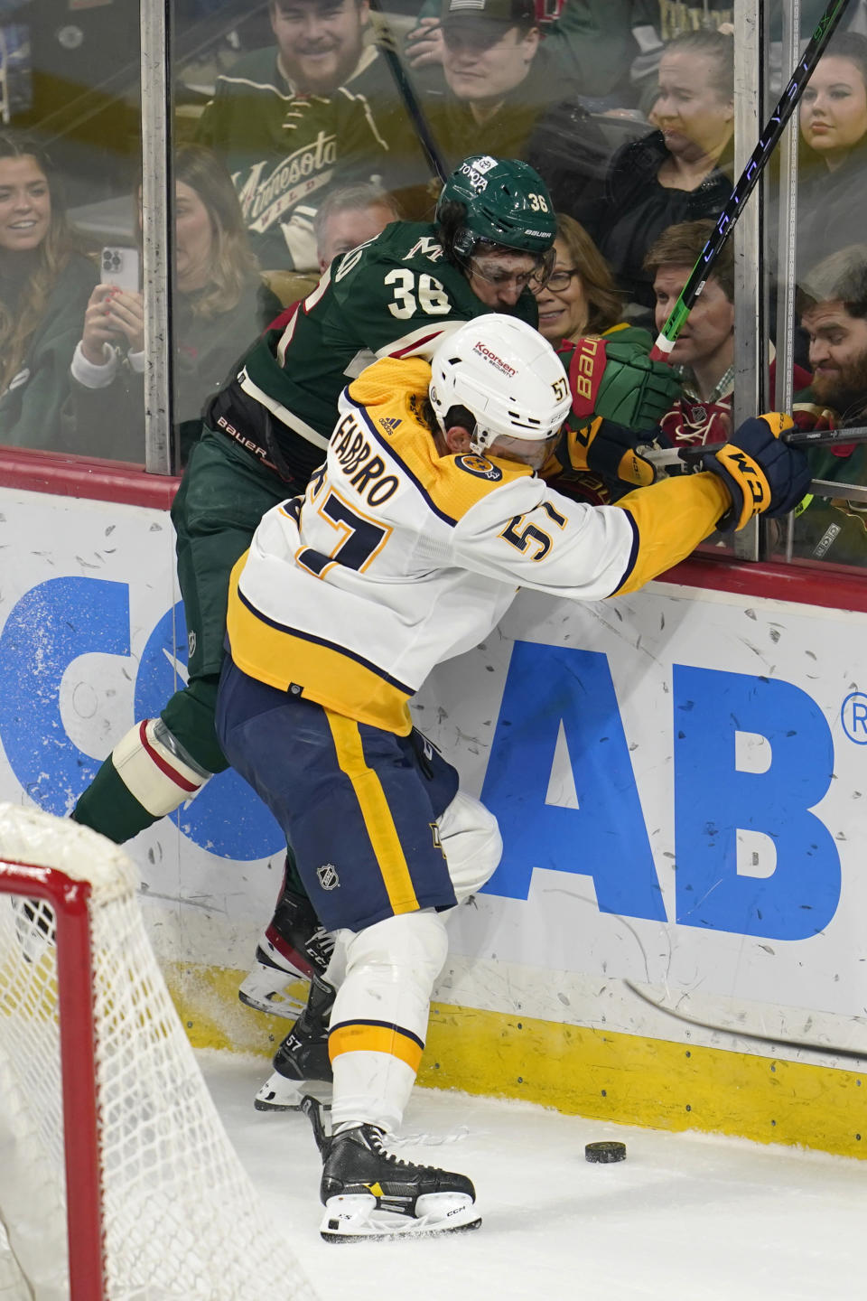 Minnesota Wild right wing Mats Zuccarello, top, and Nashville Predators defenseman Dante Fabbro battle for the puck during the first period of an NHL hockey game Sunday, Feb. 19, 2023, in St. Paul, Minn. (AP Photo/Abbie Parr)