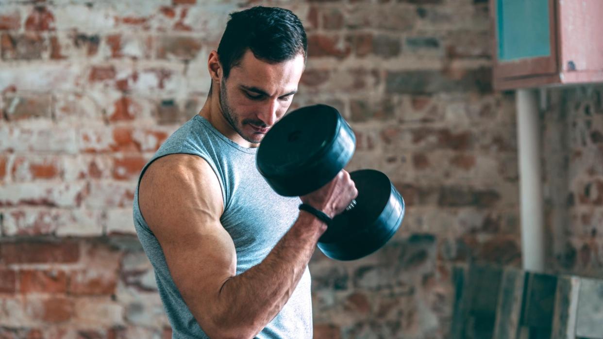  A man doing a dumbbell bicep curl. 