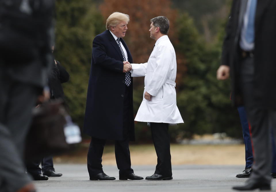 FILE - In this Friday, Jan. 12, 2018 file photo, President Donald Trump shakes hands with White House physician Dr. Ronny Jackson as he boards Marine One to leave Walter Reed National Military Medical Center in Bethesda, Md., after his first medical check-up as president. On Friday, June 14, 2019, The Associated Press reported on stories circulating online incorrectly asserting that Trump has to release results of his an annual physical exam to the public, and arguing that Speaker of the House Nancy Pelosi should be required to do the same. In fact, no elected official, including the U.S. president, is required to undergo or disclose results of a yearly health checkup. (AP Photo/Carolyn Kaster)