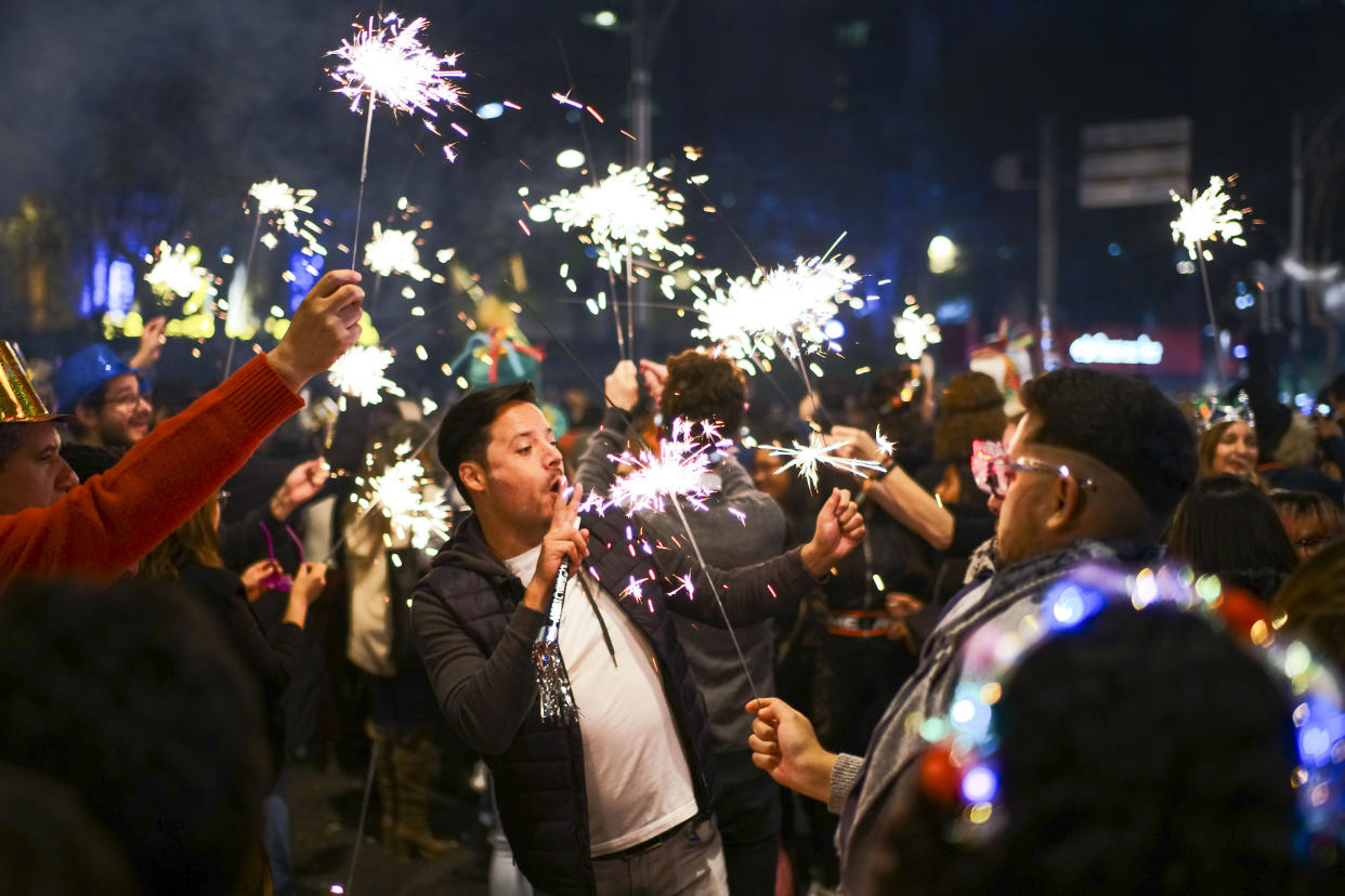 BEIJING, Jan. 2, 2020  People hold firecrackers while celebrating the New Year in Mexico City, capital of Mexico, Jan. 1, 2020. (Photo by Xin Yuewei / Xinhua via Getty Images)