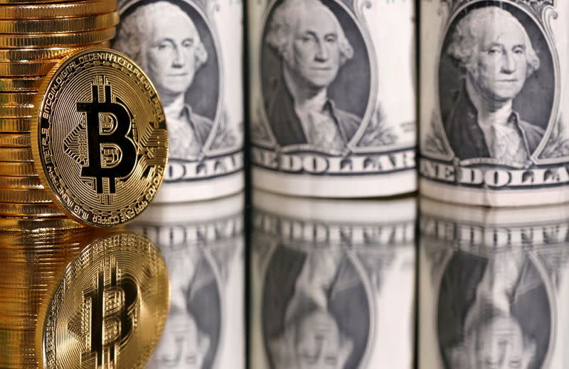 FILE PHOTO: Representations of bitcoin and U.S. dollar banknotes are seen in this illustration