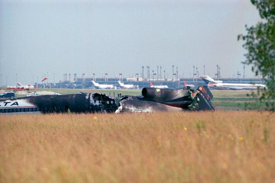 Aug. 31, 1988: The wreckage of Delta 1141 at Dallas-Fort Worth International Airport. A Boeing 727 with Delta livery similar to the one that crashed is seen in the distance to the right.