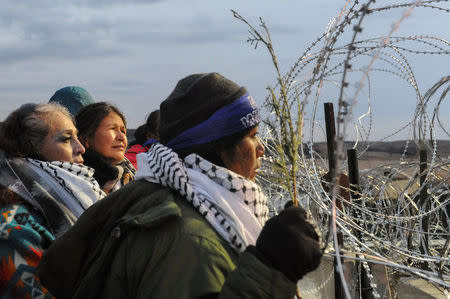 Women hold a prayer ceremony on Backwater Bridge during a protest against plans to pass the Dakota Access pipeline near the Standing Rock Indian Reservation, near Cannon Ball, North Dakota, U.S. November 27, 2016. REUTERS/Stephanie Keith