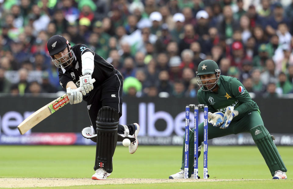 New Zealand's captain Kane Williamson, left, plays a shot as Pakistan's captain Sarfaraz Ahmed watches on during the Cricket World Cup match between New Zealand and Pakistan at the Edgbaston Stadium in Birmingham, Wednesday, June 26, 2019. (AP Photo/Rui Vieira)