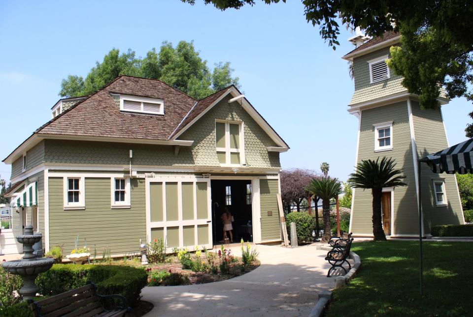 The carriage house and water pump tower at the rear of the grounds of the Heritage House, as seen on April 20, 2024. There is an entire apartment included on the second floor.