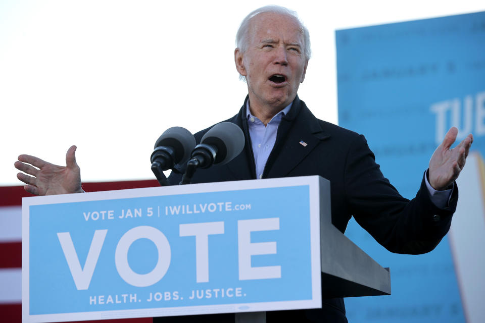 ATLANTA, GEORGIA - JANUARY 04: President-elect Joe Biden addresses a campaign rally with Democratic candidates for the U.S. Senate Jon Ossoff and Rev. Raphael Warnock the day before their runoff election in the parking lot of Center Parc Stadium January 04, 2021 in Atlanta, Georgia. Biden's trip comes a day after the release of a recording of an hourlong call where President Donald Trump seems to pressure Georgia Secretary of State Brad Raffensperger to “find” the votes he would need to reverse the presidential election outcome in the state. (Photo by Chip Somodevilla/Getty Images)