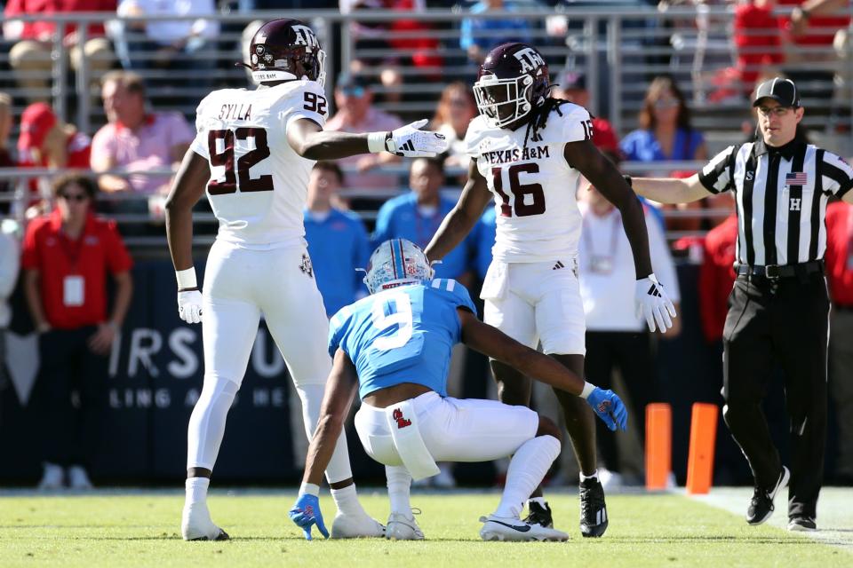 November 4, 2023;  Oxford, Mississippi, USA;  Texas A&M Aggies defensive linemen Malick Sylla (92) and defensive back Sam McCall (16) react after a pass breakup against the Mississippi Rebels during the first half at Vaught-Hemingway Stadium.  Mandatory Credit: Petre Thomas-USA TODAY Sports