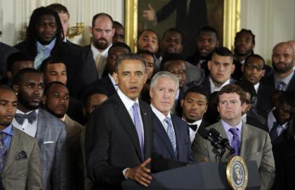 Seattle Seahawks Executive Vice President of Football Operations and Head Coach Pete Carroll, center, and Executive Vice President/General Manager John Schneider, right. and otjers, listen as President Barack Obama speaks in the East Room of the White House in Washington, Wednesday, May 21, 2014, during a ceremony where the president honored the NFL Super Bowl champion Seattle Seahawks football team. The Seahawks defeated the Denver Broncos in Super Bowl XLVIII. (AP Photo/Susan Walsh)