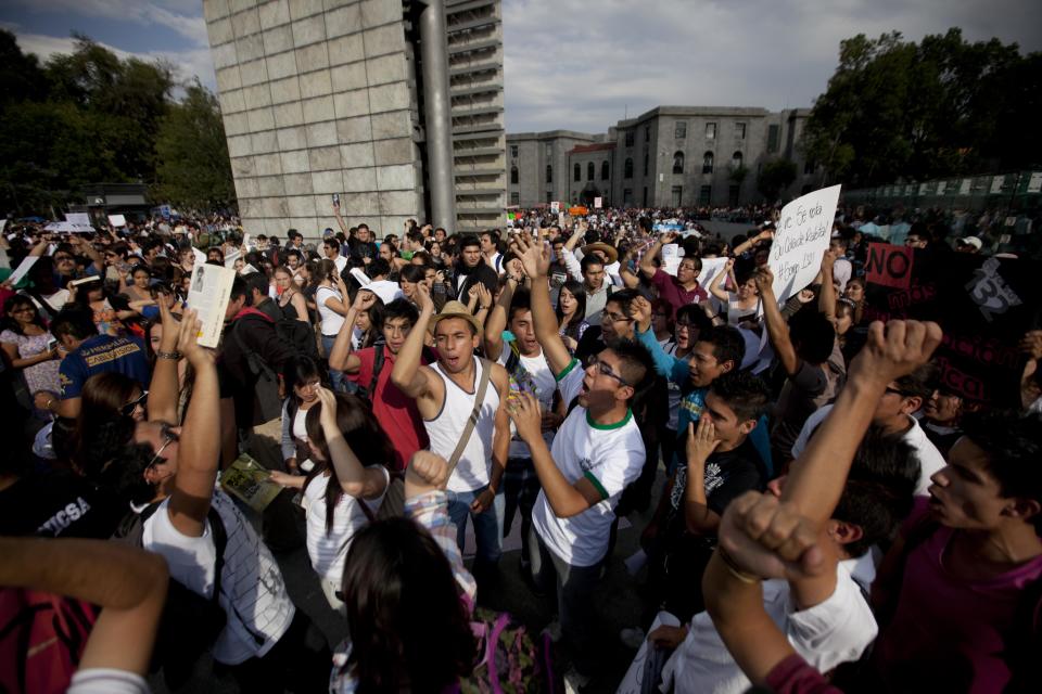 Students shout slogans during a demonstration to protest a possible return of the old ruling Institutional Revolutionary Party (PRI) in Mexico City, Wednesday, May 23, 2012. Demonstrators also protested against what students perceive as a biased coverage by major Mexican TV networks of the presidential elections campaign, which they claim to be directed in favor of PRI's candidate Enrique Pena Nieto. Mexico will hold presidential elections on July 1. (AP Photo/Eduardo Verdugo)