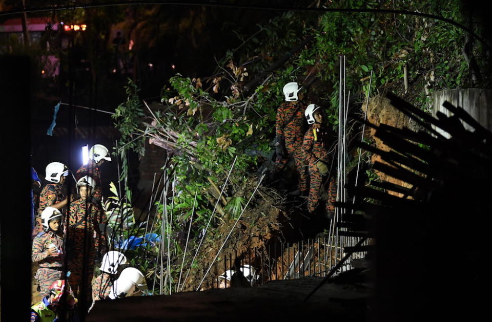 Fire and Rescue Department personnel search for victims of a landslide in Tanjung Bungah, George Town June 25, 2019. — Bernama pic