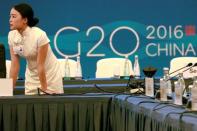 A hostess prepares for the G20 Finance Ministers and Central Bank Governors Meeting to be held over the weekend in Chengdu in Southwestern China's Sichuan province, July 22, 2016. REUTERS/Ng Han Guan/Pool