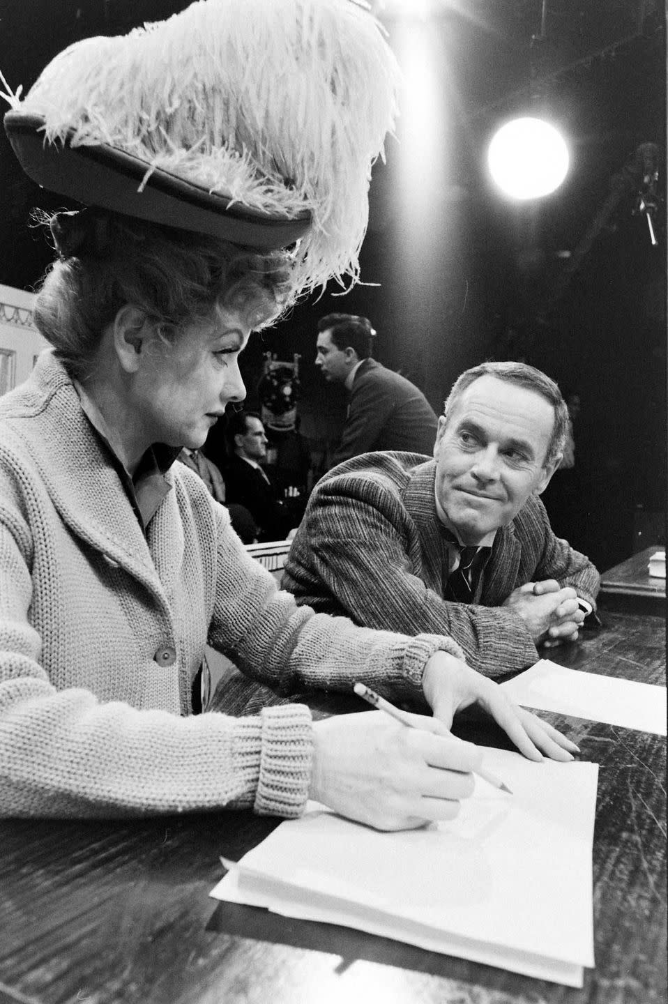 <p>In 1962, Lucille premiered her TV special, <em>The Good Years</em>. Here, she wears a vintage hat, while running lines with her costar, Henry Fonda. </p>