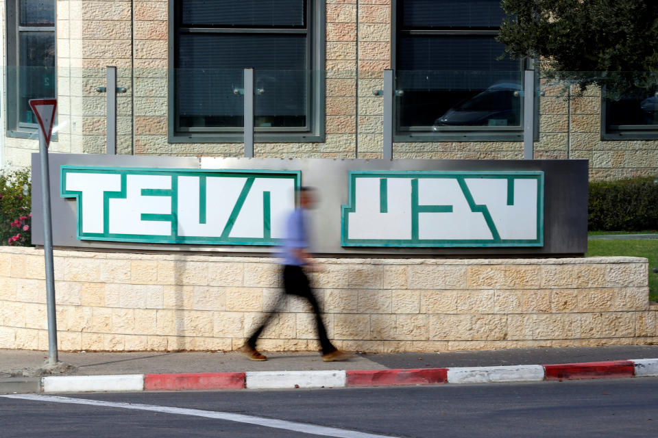 A man walks past the logo of Teva Pharmaceutical Industries at their plant in Jerusalem December 14, 2017. REUTERS/Ammar Awad