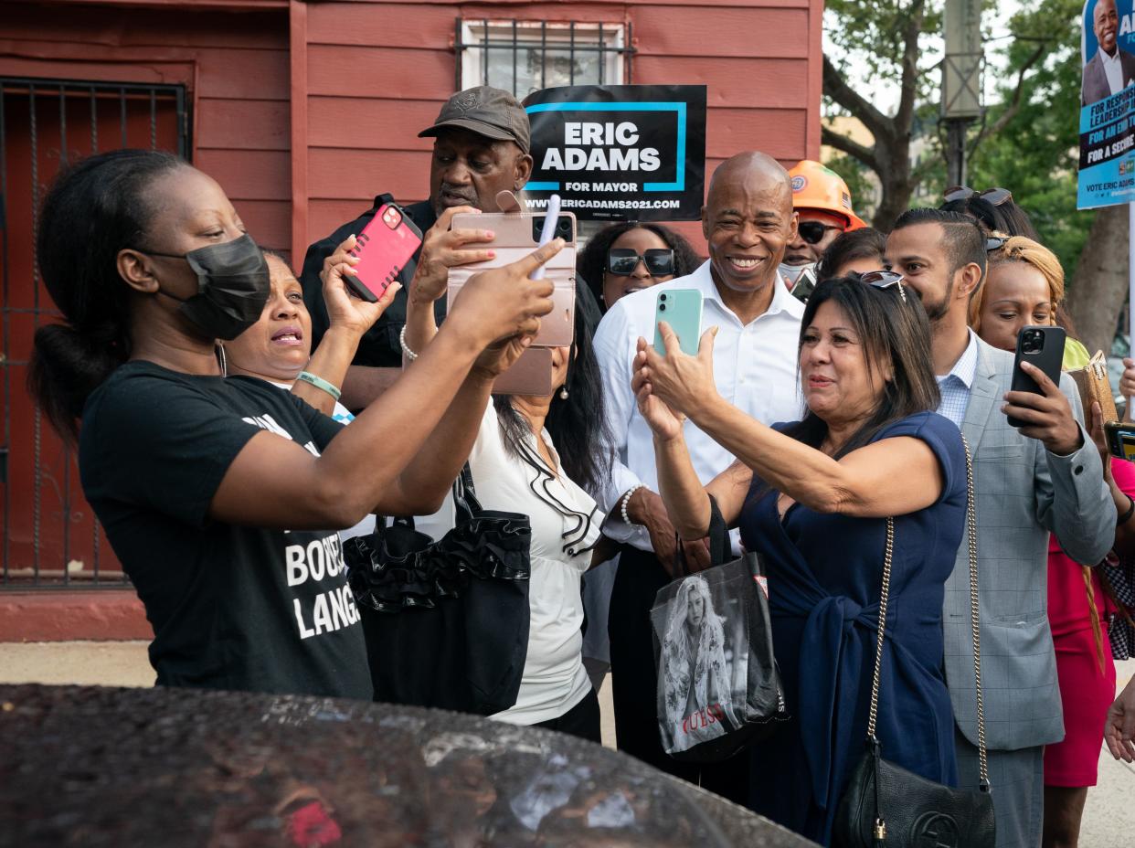 Eric Adams takes selfies with supporters after voting at P.S. 81 on Tuesday, June 22, 2021, in Brooklyn, New York.