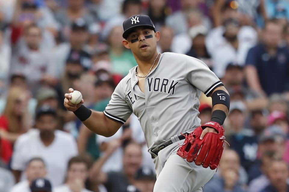 New York Yankees' Rougned Odor holds onto the ball on the infield single by Boston Red Sox's Jose Iglesias to load the base during the fifth inning of a baseball game, Saturday, Sept. 25, 2021, in Boston. (AP Photo/Michael Dwyer)