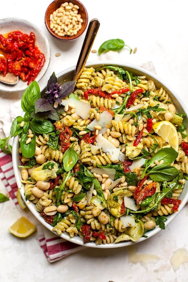 <strong><a href="https://www.twopeasandtheirpod.com/sun-dried-tomato-white-bean-artichoke-pesto-pasta-salad/" target="_blank" rel="noopener noreferrer">Get the Sun-Dried Tomato, White Bean and Artichoke Pesto Pasta Salad recipe from Two Peas and Their Pod</a></strong>