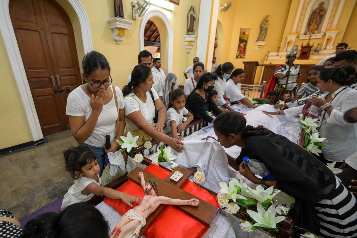 Catholic devotees kisses the jesus christ statue during after mass on Good Friday at St. Peter's Church in Mabima, in the suburb of Colombo on April 7, 2023. (Photo by ISHARA S. KODIKARA / AFP) (Photo by ISHARA S. KODIKARA/AFP via Getty Images)