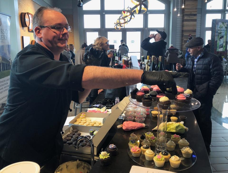 Paul Piorkowski from New York Kitchen brings out the sweets for a 10th anniversary celebration of Taste NY at the Finger Lakes Welcome Center.