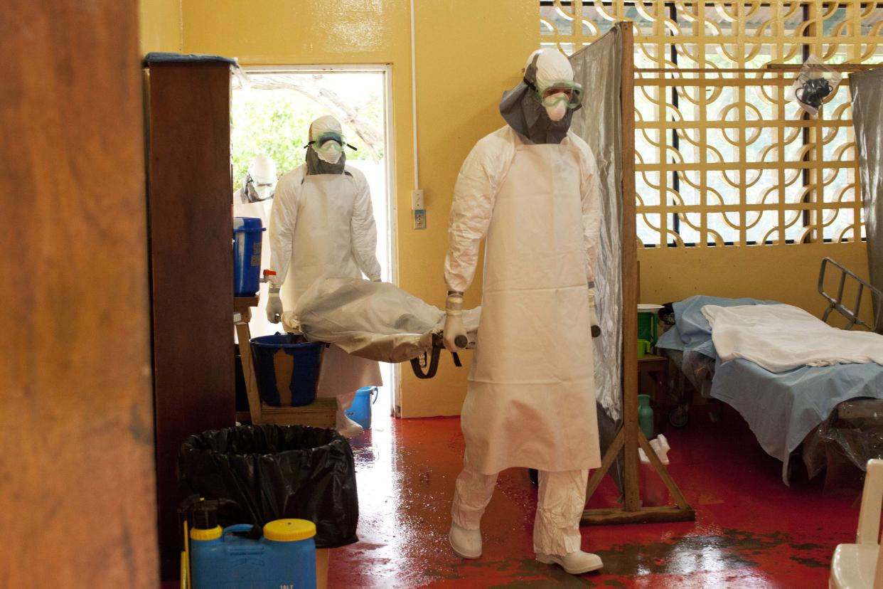 Dr. Kent Brantly (R) carrying in an Ebola patient before he became contaminated with the disease himself. (Courtesy Samaritan's Purse)