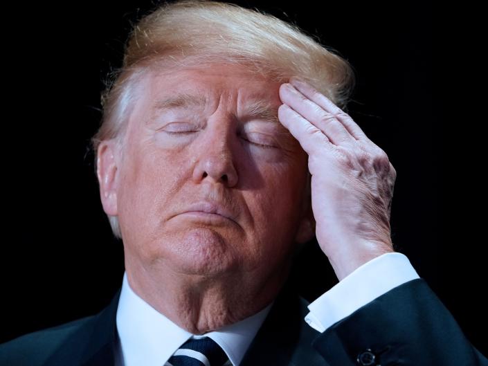 Donald Trump touches his head