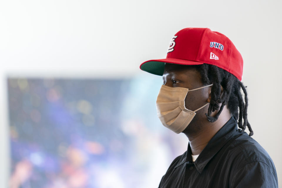 Bobby Carter, a leader on the Tiny Desk Concerts team for NPR Music, watches while Becky G performs a run-through prior to a taping for NPR's Tiny Desk concert series on Wednesday, Aug. 30, 2023, in Washington. (AP Photo/Stephanie Scarbrough)