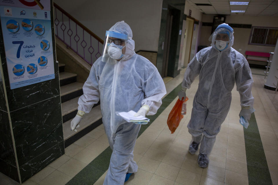 Palestinian medics wear protective suits as they take part in a simulation of possible coronavirus infections in Gaza City, Saturday, July 18, 2020. (AP Photo/Khalil Hamra)