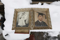 Photographs of Elliott Miller's wedding day and graduation lay on a snow covered bench as Jeanene Miller tries to dry out the pictures of her in-laws which were damaged during floods caused by Superstorm Sandy, Thursday, Nov. 8, 2012, in Point Pleasant, N.J. The New York-New Jersey region woke up to wet snow and more power outages Thursday after the nor'easter pushed back efforts to recover from Superstorm Sandy, that left millions powerless and dozens dead last week. (AP Photo/Julio Cortez)