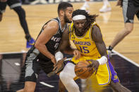 Los Angeles Lakers center Montrezl Harrell (15) drives to the basket as he's defended by Sacramento Kings guard Cory Joseph (9) during the second half of an NBA basketball game in Sacramento, Calif., Wednesday, March 3, 2021. (AP Photo/Hector Amezcua)