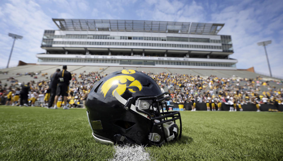 A helmet sits on the field before Iowa's NCAA college football spring game, Saturday, April 23, 2016, in Iowa City, Iowa. (AP Photo/Charlie Neibergall)