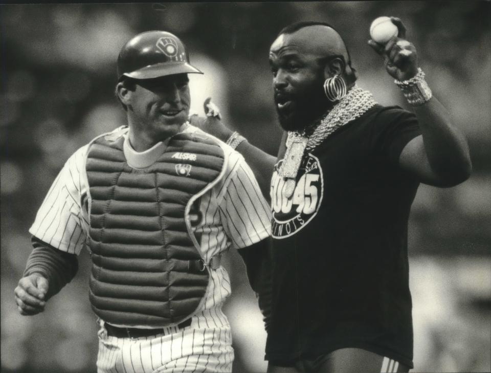 Actor Mr. T (right) shares a laugh with Milwaukee catcher Joe Kmak after throwing out the first pitch at the White Sox-Brewers game in 1993.