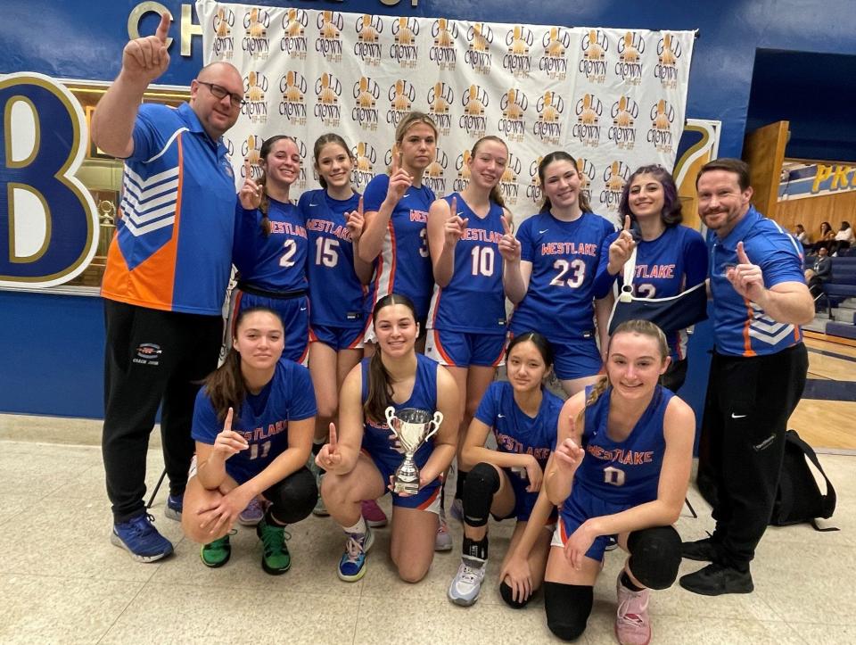 The Westlake High girls basketball team poses with the championship trophy after winning the Bonita Vista Gold Crown Tournament.