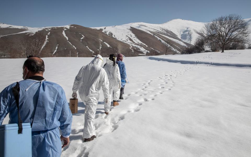 Members of the Gevas Public Health Center vaccination team walk through the snow to vaccinate a resident with the Chinese Sinovac Coronavac vaccine during a house call in the village of Kayalar - Chris McGrath/Getty Images