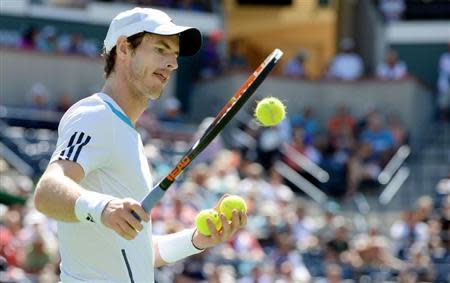 Mar 12, 2014; Indian Wells, CA, USA; Andy Murray (GBR) selects tennis balls as he prepares to serve during his match against Milos Raonic (not pictured) during the BNP Paribas Open at the Indian Wells Tennis Garden. Raonic won 4-6, 7-5, 6-3. Mandatory Credit: Jayne Kamin-Oncea-USA TODAY Sports