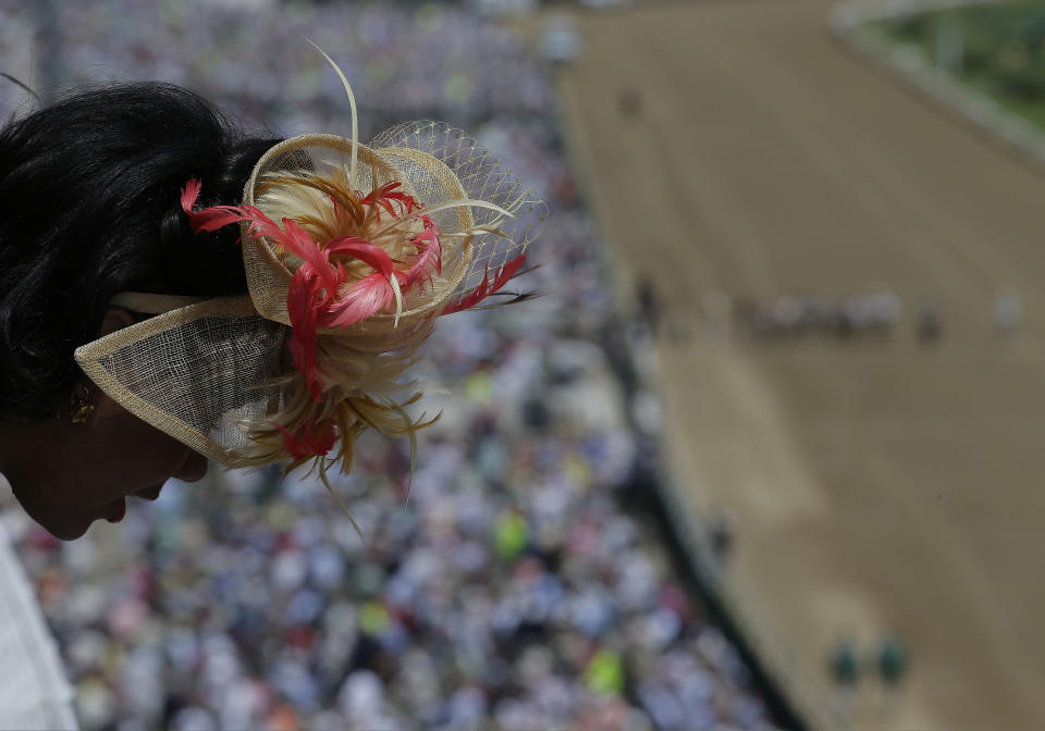 A woman looks out over a balcony before the 140th running of the Kentucky Derby horse race at Churchill Downs Saturday, May 3, 2014, in Louisville, Ky. (AP Photo/Charlie Riedel)