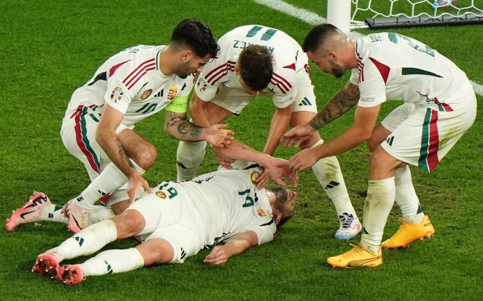 Hungary's Barnabas Varga (bottom) is assisted by his team mates after colliding with Scotland goalkeeper Angus Gunn (not pictured)