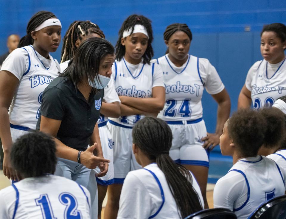 Wildcats head coach Jade Brown talks with her team in between periods during the Navarre vs Washington girls basketball game at Booker T. Washington High School in Pensacola on Wednesday, Nov. 17, 2021.