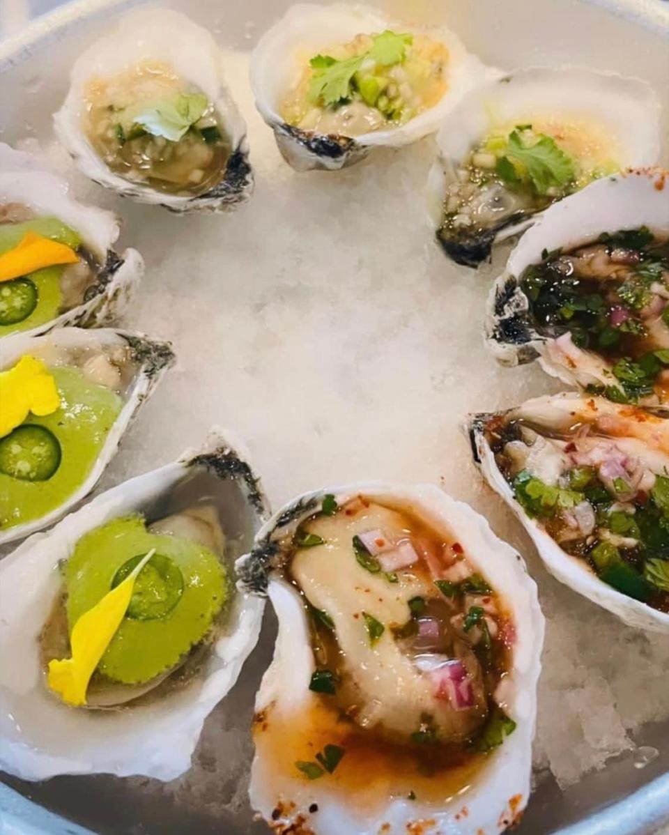 The oyster flight at Jules@Markets in Bristol features West Coast oysters topped with three different sauces.