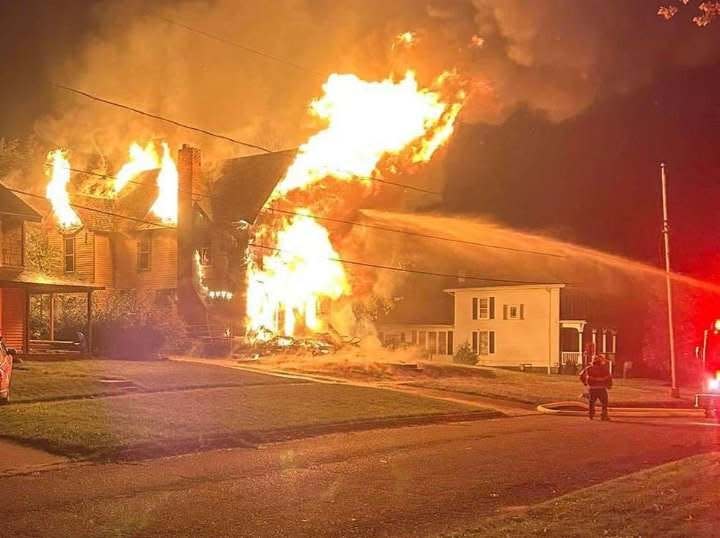 Firefighters make an initial attack on a fully engulfed structure fire on Lafayette Street in Hudson on Oct. 9.