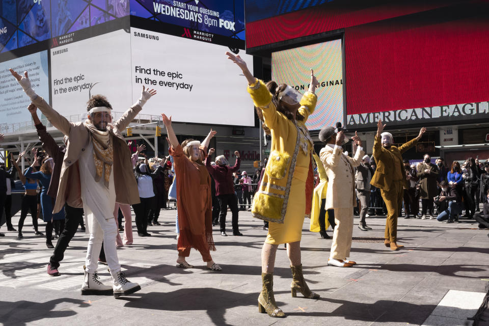 Broadway actors perform in New York's Times Square, Friday, March 12, 2021. The "We Will Be Back" program commemorates the lost year on Broadway due to the coronavirus pandemic and attempts to shine some hope on the year to come. (AP Photo/Mark Lennihan)