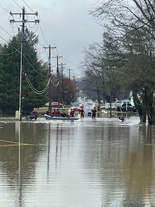 Members of the Hendersonville Fire Department and the Henderson County Rescue Squad help evacuate two residents and their pets from a flooded residence on Jan. 9 on Dana Road in Hendersonville. Hendersonville Police Department also assisted on the call.