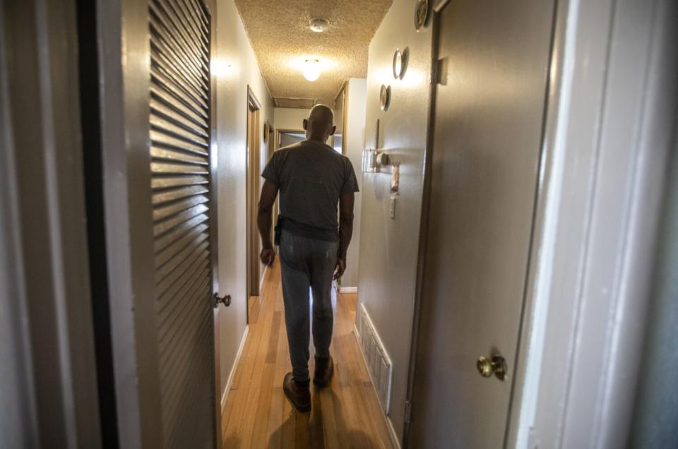 A person walks down a hallway.