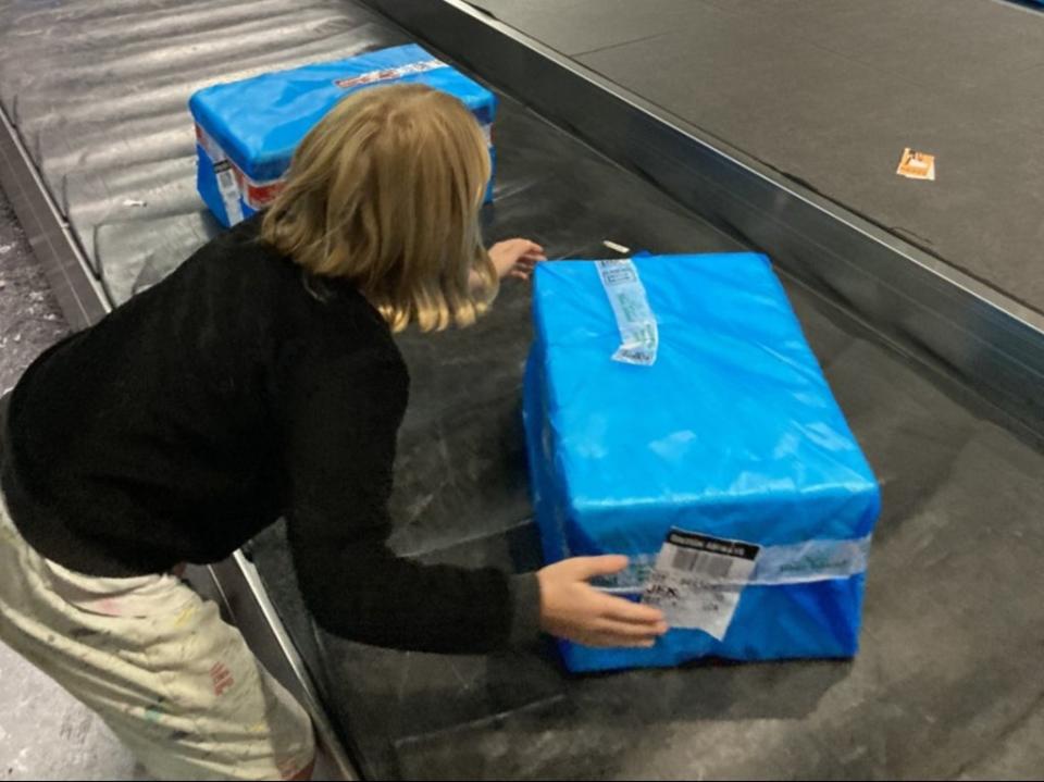 Mrs Braunholtz’s daughter attempts to lift the ‘heavy’ crate (Becca Braunholz)