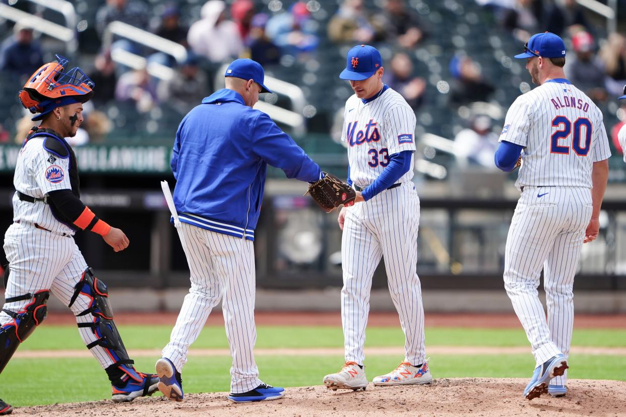 Apr 4, 2024; New York City, New York, USA; New York Mets manager Carlos Mendoza (64) takes out New York Mets pitcher Drew Smith (33) during the seventh inning against the Detroit Tigers at Citi Field. Mandatory Credit: Gregory Fisher-USA TODAY Sports