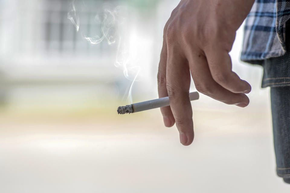 a cigarette being held between fingers